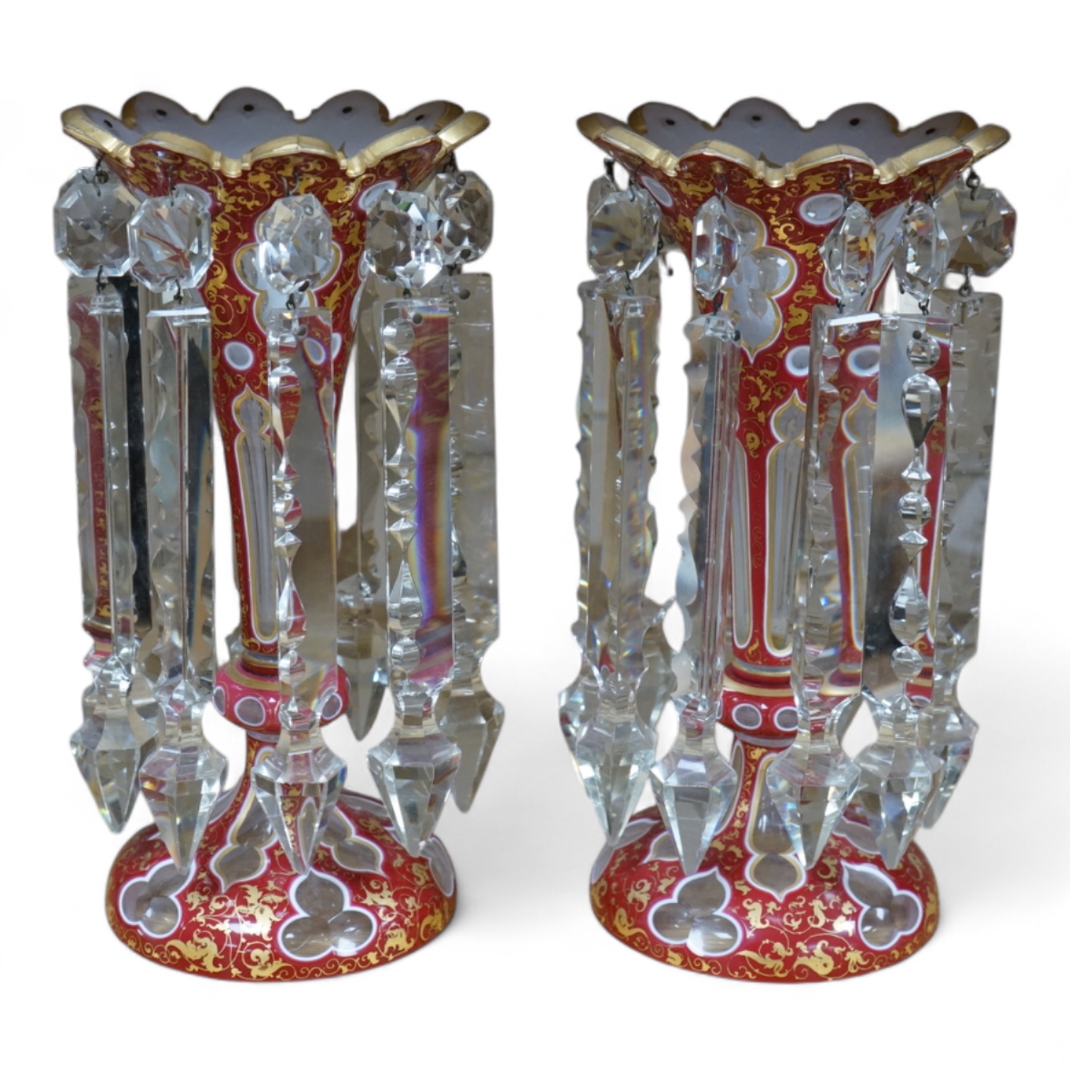 A pair of Bohemian ruby-overlaid table lustres, 26cm high. Condition - some chipping to the glass lustre drops